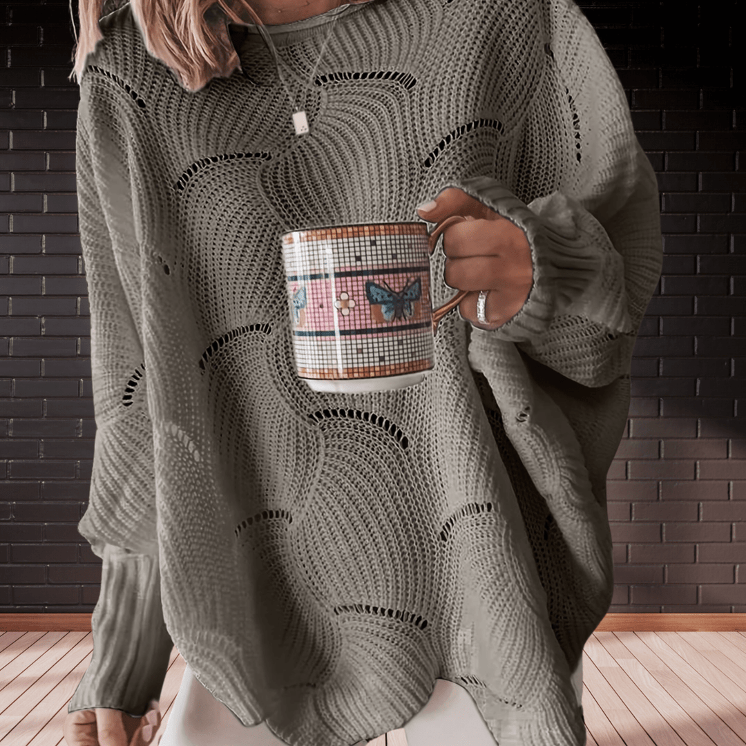Relaxed fit women's autumn sweater with unique eyelet detail and an elegant asymmetric hem. Cozy fall fashion.