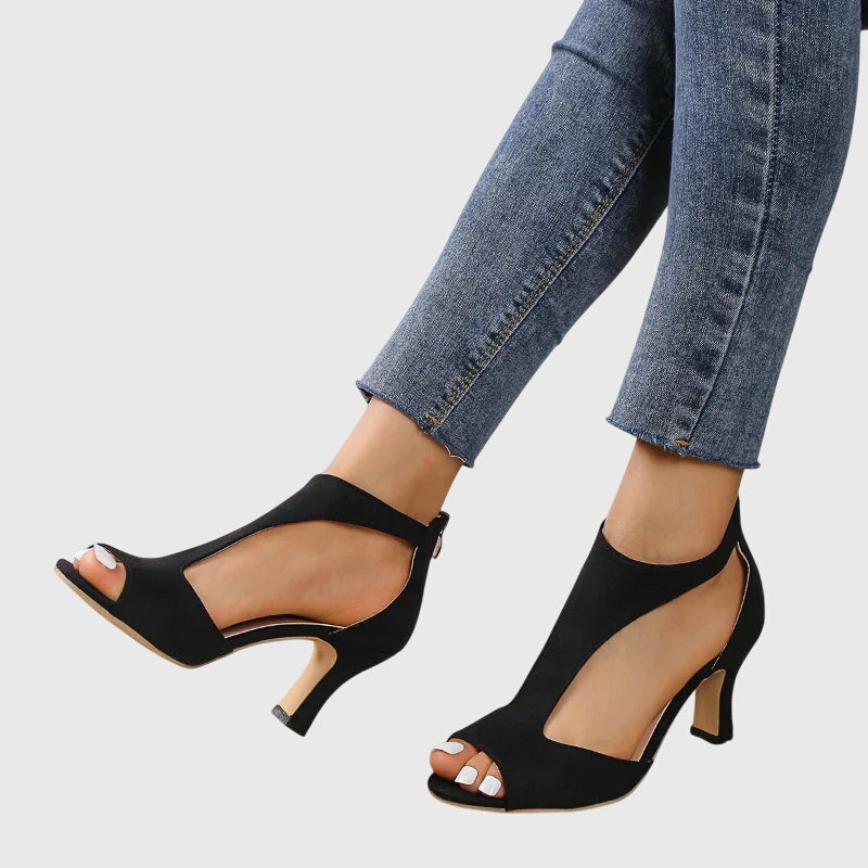 Modern women's peep toe block heel sandals with stylish cut-out details and comfort.