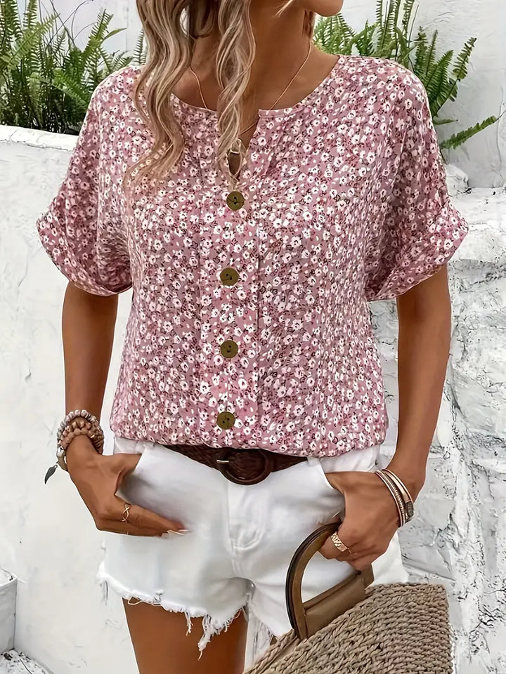 Elegant women's floral print blouse with chic design. Stylish button top, great for spring/summer fashion.