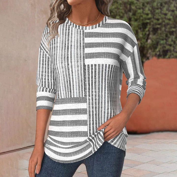 Chic women's gray striped blouse with three-quarter sleeves and a round neck, perfect for casual or office wear.