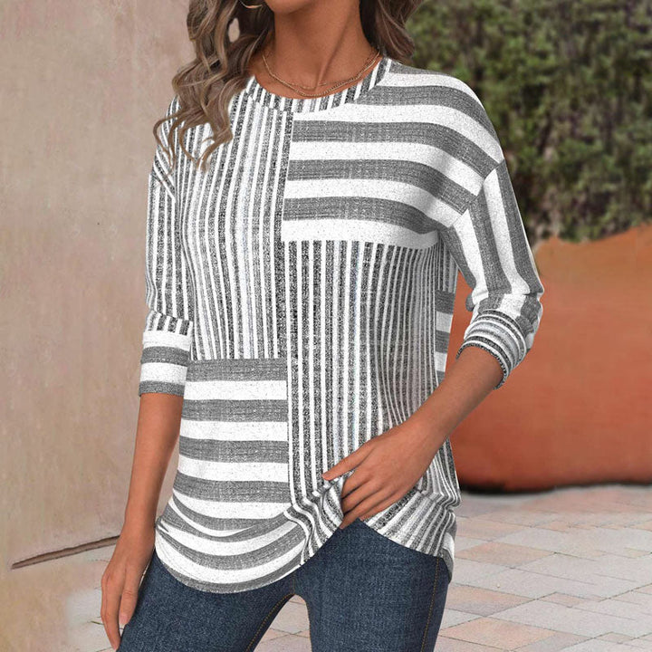 Effortless gray striped women's blouse featuring three-quarter sleeves and a comfortable round neck design.