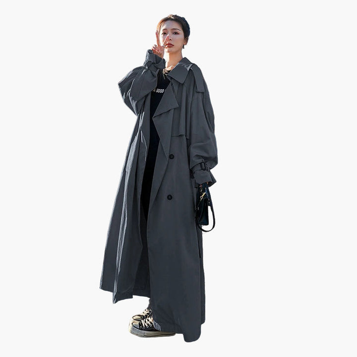 Chic women's loose-fit double-breasted trench coat in a classic long style, perfect for outerwear fashion.