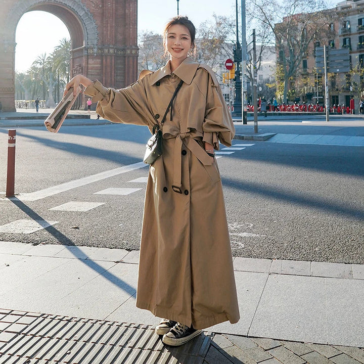 Women's chic long loose-fit trench coat in a versatile color with double-breasted detail, elegant outerwear.