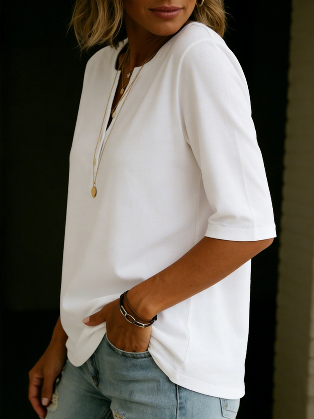 Detail shot of the notch neck and 3/4 sleeves on a comfortable relaxed fit women's casual blouse.