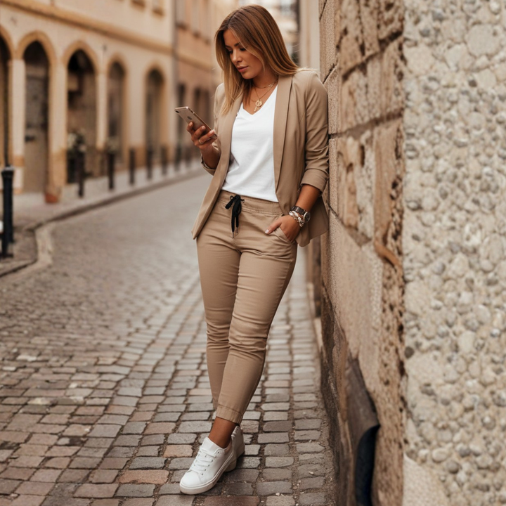Tailored women's chic ruched sleeve blazer and elegant jogger set. Perfect for stylish business casual looks.