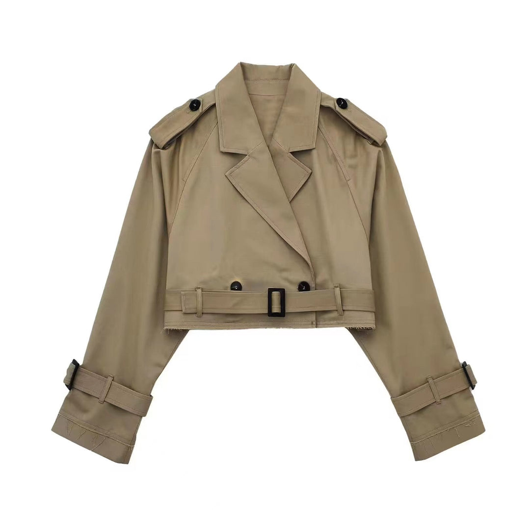 Close-up of a women's double-breasted trench coat, highlighting the fabric and tailored fit.