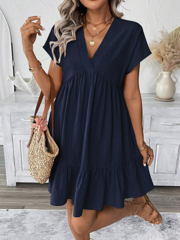 Casual chic women's mini dress, sleeveless V-neck with ruffle hem. Ideal for summer parties & fashion.