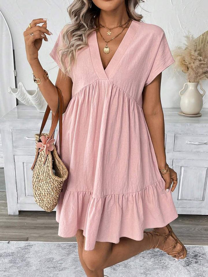 Fashionable women's summer mini dress. Sleeveless V-neck, elegant ruffle hem. Great for vacation & casual wear.