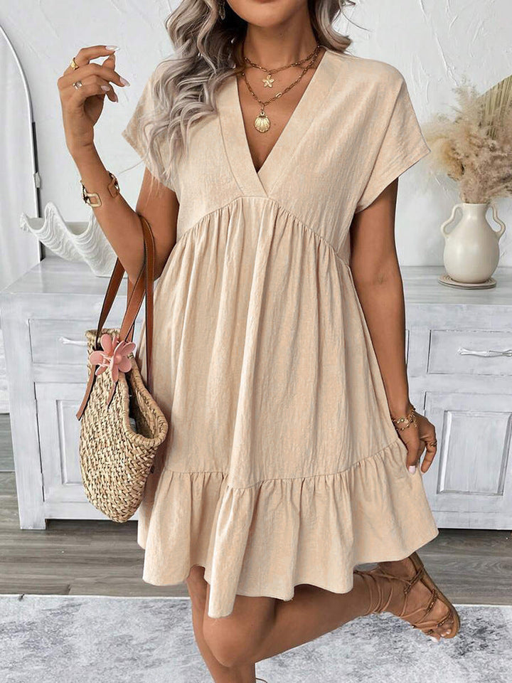 Stylish chic women's sleeveless V-neck mini dress, featuring a flirty ruffle hem. Perfect summer party or vacation.