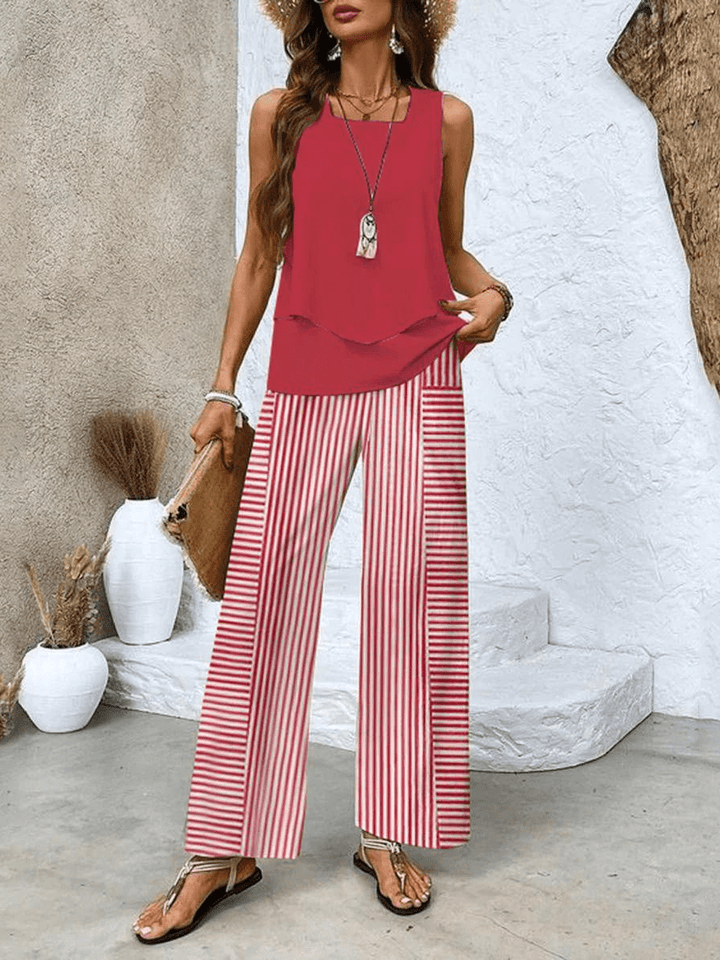 Elegant women's vacation outfit: a chic two-piece summer set with a flowy blouse and wide-leg trousers.