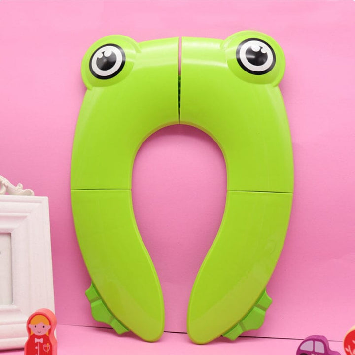 Pink children's folding portable potty seat, unfolded, ready for use, travel toilet seat for kids