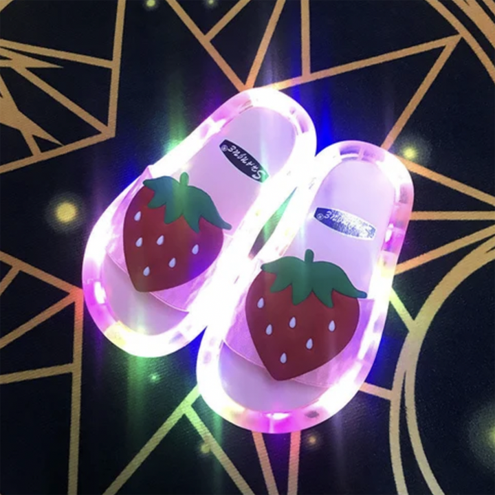 Smiling child playing outdoors wearing their new LED light-up summer sandals.