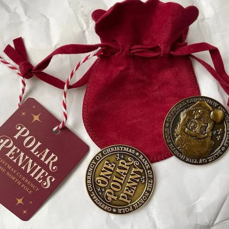 Detailed image of Christmas Collectible Polar Pennies nestled within a luxurious velvet pouch