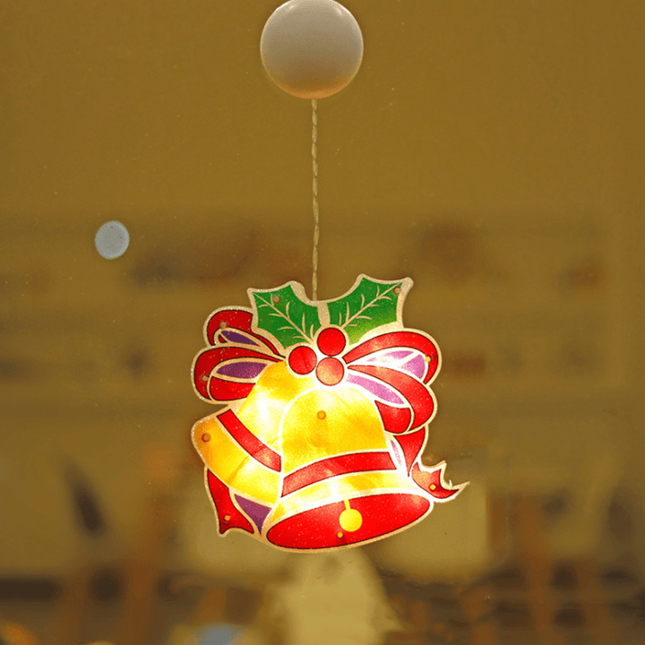 A series of Christmas LED lights in various shapes, attached to a window with suction cups, vibrant holiday scene