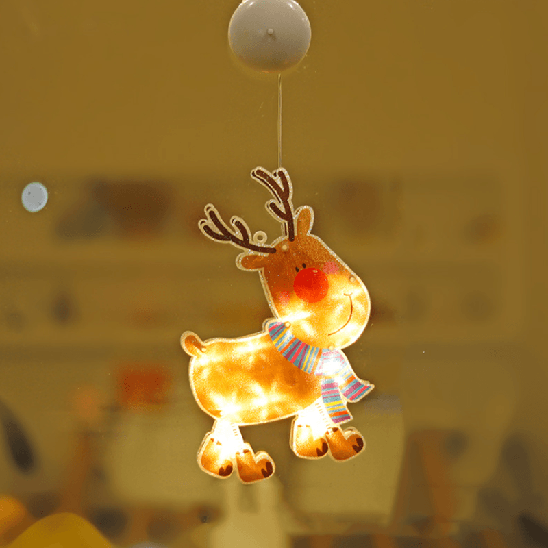 Hand holding a Christmas Window Suction Cup LED Light before attachment, showing product readiness
