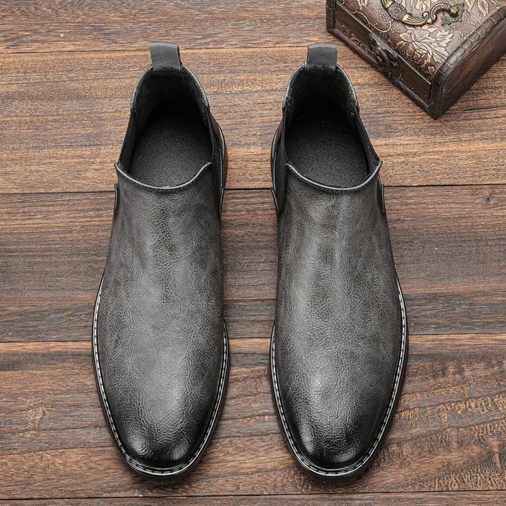 Dressy black men's Chelsea boots, elegant leather finish, perfect for formal or business casual looks.