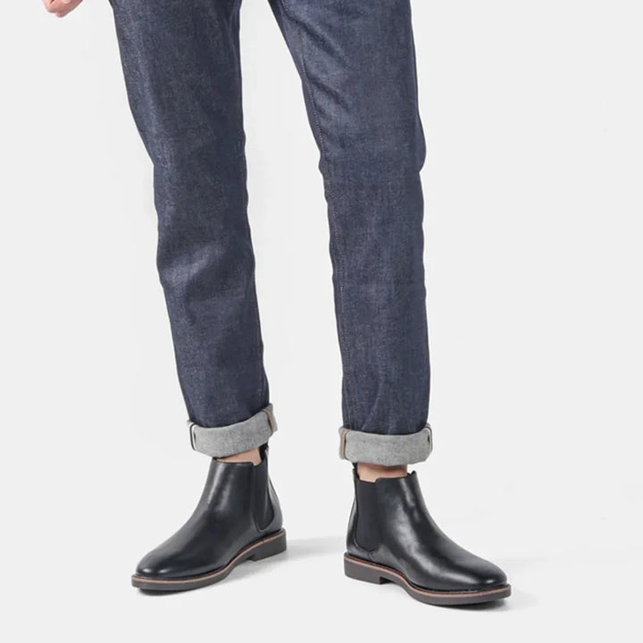Comfortable men's Chelsea boots in rich brown, slip-on ankle style, suitable for various outfits.