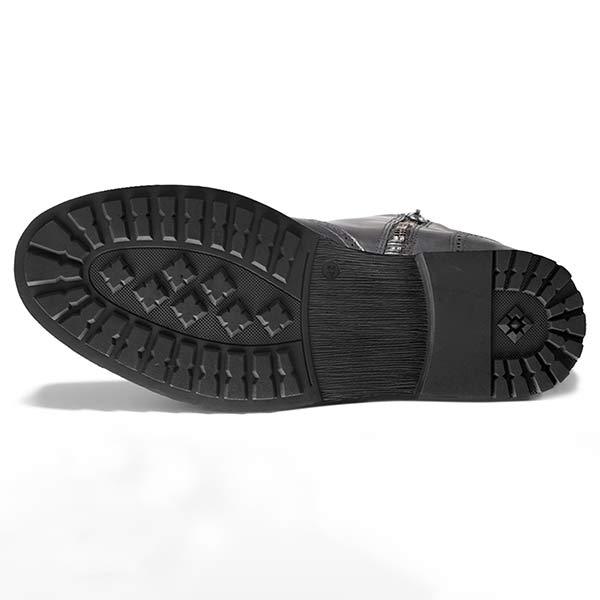 Close-up of classic men's Chelsea boot, black faux leather texture, elastic side, timeless versatile shoe.