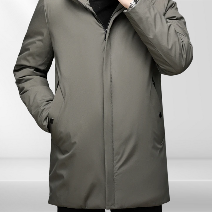 Man models a warm, hooded winter jacket; stylish men's fashion for fall, cold weather & outdoor adventures.