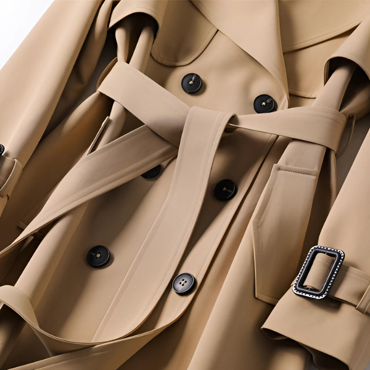 Close-up of a women's classic trench coat detail: elegant fabric, belt, and buttons. Versatile outerwear.