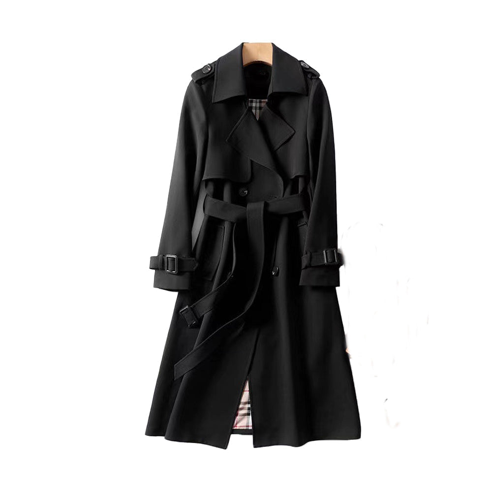 Stylish woman models a long classic double-breasted trench coat, perfect elegant and versatile women's outerwear.