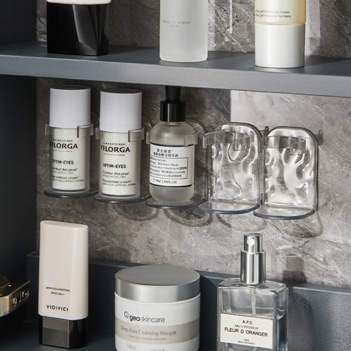 Storage solution: Clear multi-hook wall rack holding various kitchen gadgets and accessories.