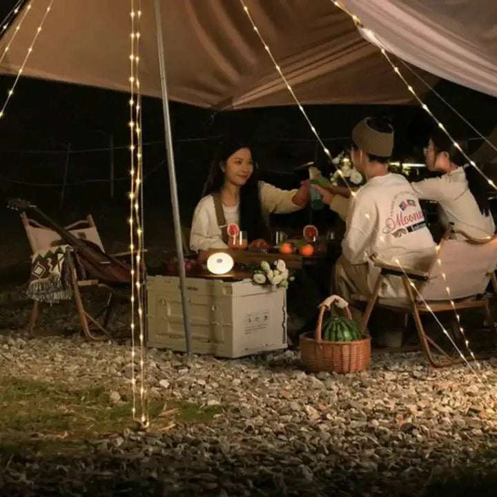 Essential portable outdoor LED lantern, featuring a collapsible design and string lights for versatile camping illumination.