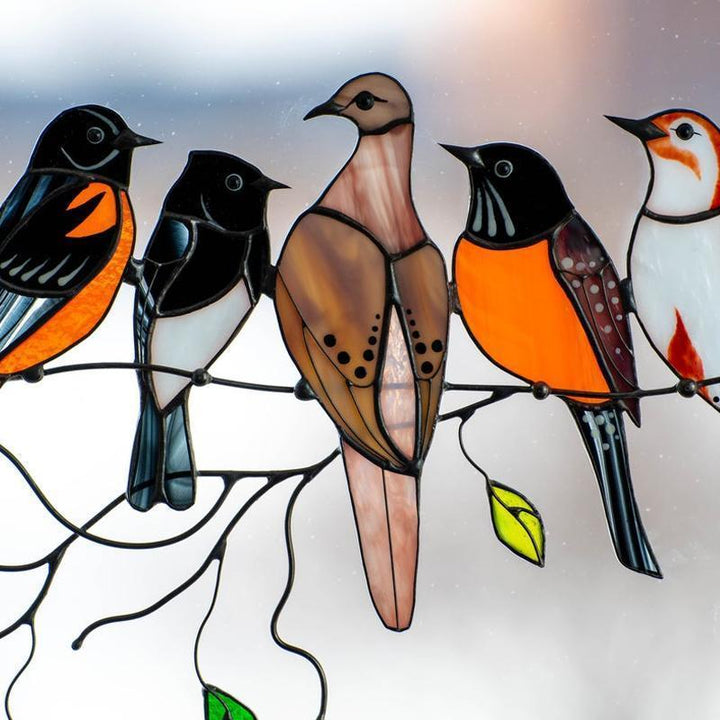 Close-up of a stained glass hummingbird window accent, intricate colorful design
