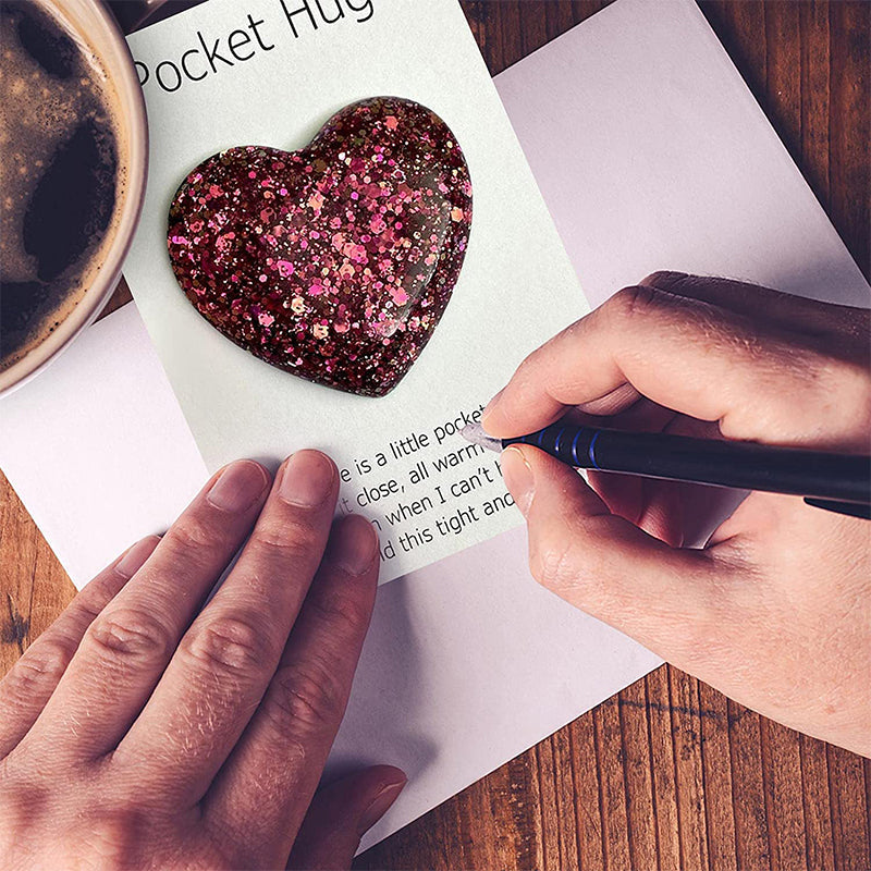 Close-up of a Pocket Hug heart charm, a thinking of you comfort gift for loved ones