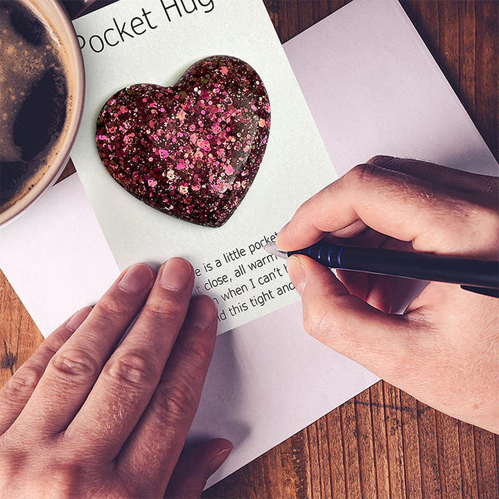 Close-up of a Pocket Hug heart charm, a thinking of you comfort gift for loved ones