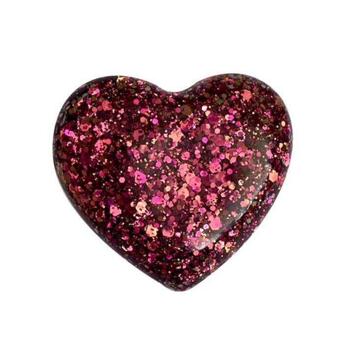 Pocket Hug heart displayed on a soft fabric, a comforting token for emotional support