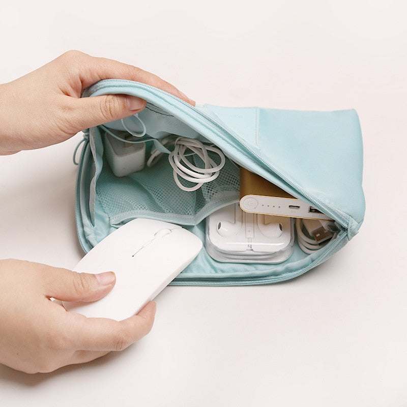 Open view: waterproof electronics & cable travel organizer, neatly storing chargers, USBs, and headphones.