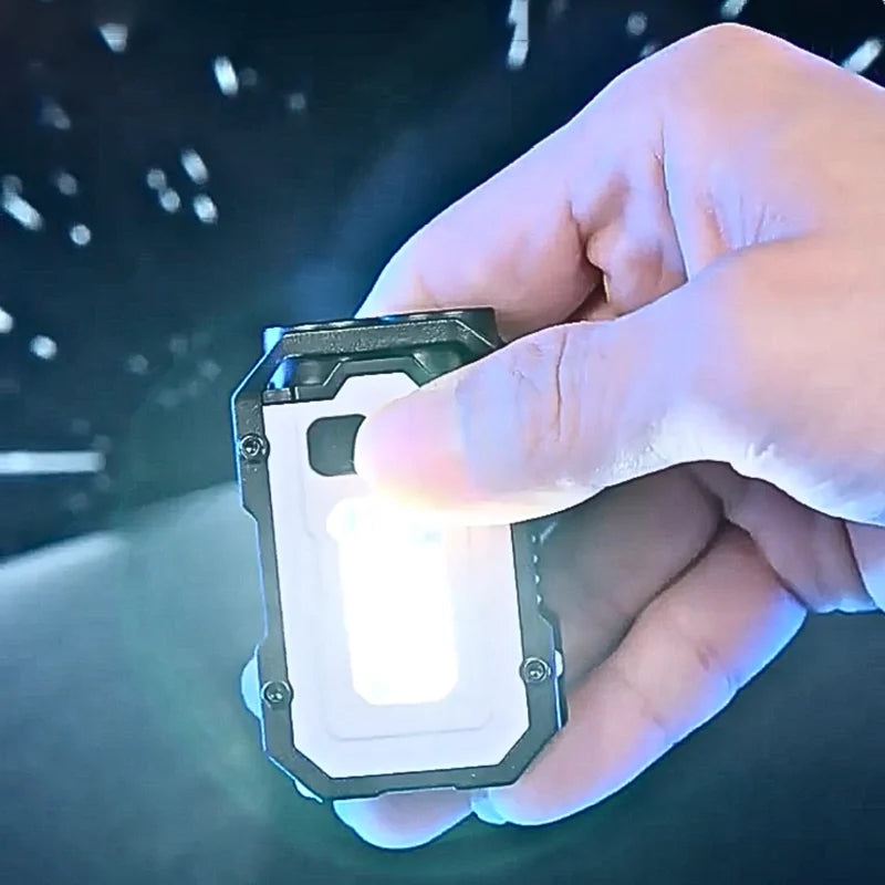 Keychain LED flashlight, rechargeable, compact design, showing UV light mode for security checks