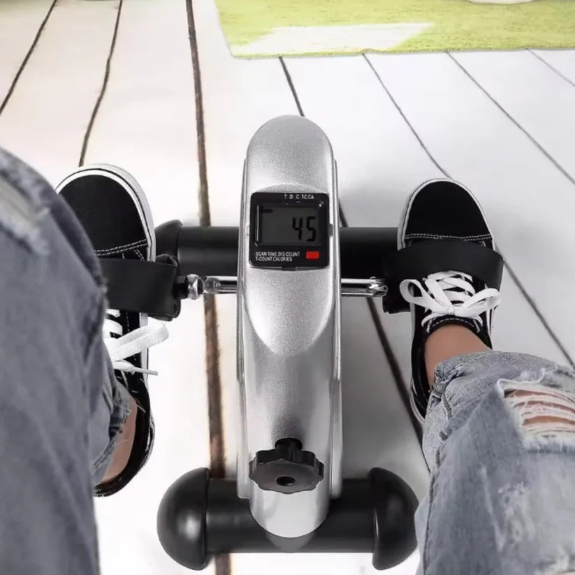 Portable mini pedal exerciser with LCD for tracking arm & leg fitness workouts.