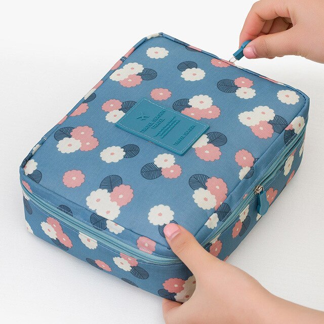 Sleek compact waterproof makeup organizer, dark blue, ideal for women's travel beauty.
