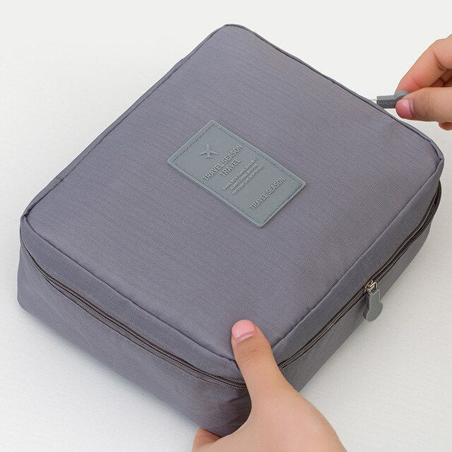 Dark blue waterproof makeup travel organizer, compact for women's daily essentials.