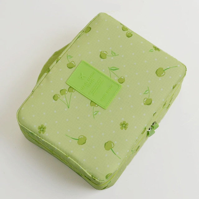 Portable waterproof makeup travel case, dark blue floral print, for women's toiletries.