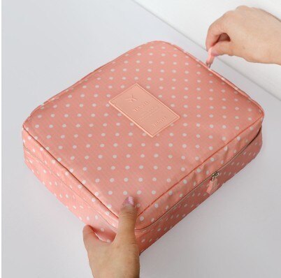 Women's dark blue waterproof cosmetic travel bag, compact design for easy packing.