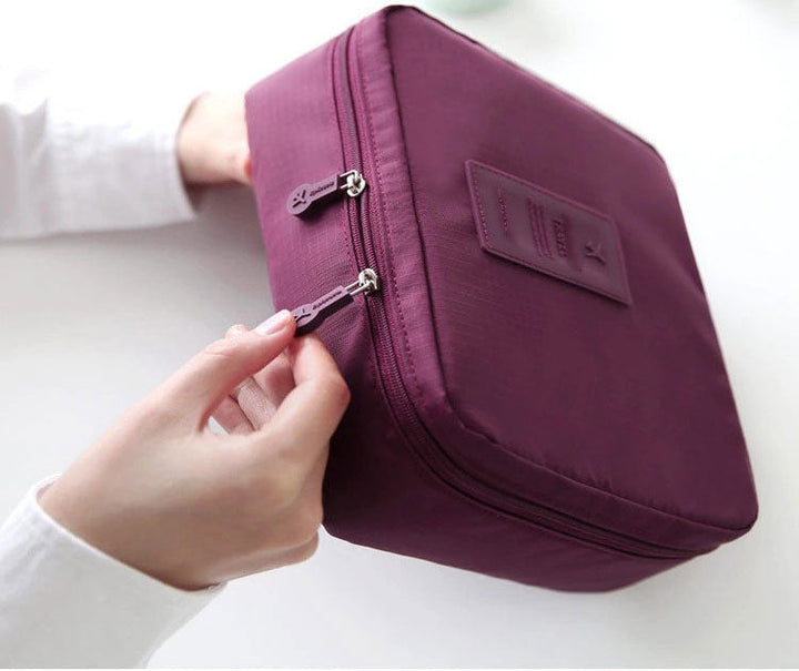 Waterproof dark blue floral makeup travel bag, small & efficient for cosmetics.
