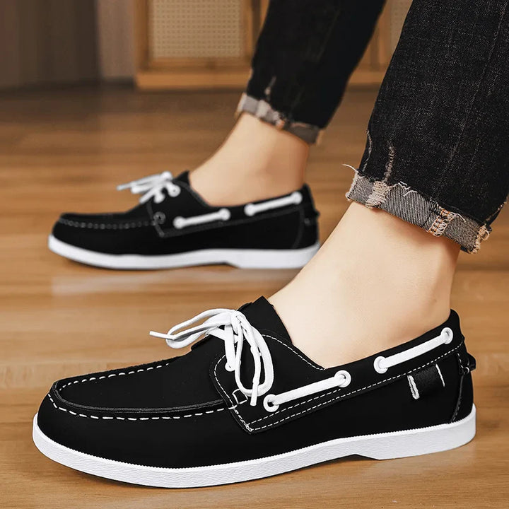 Corvan men's deck loafers paired with a striped shirt, completing a classic nautical-inspired casual look.