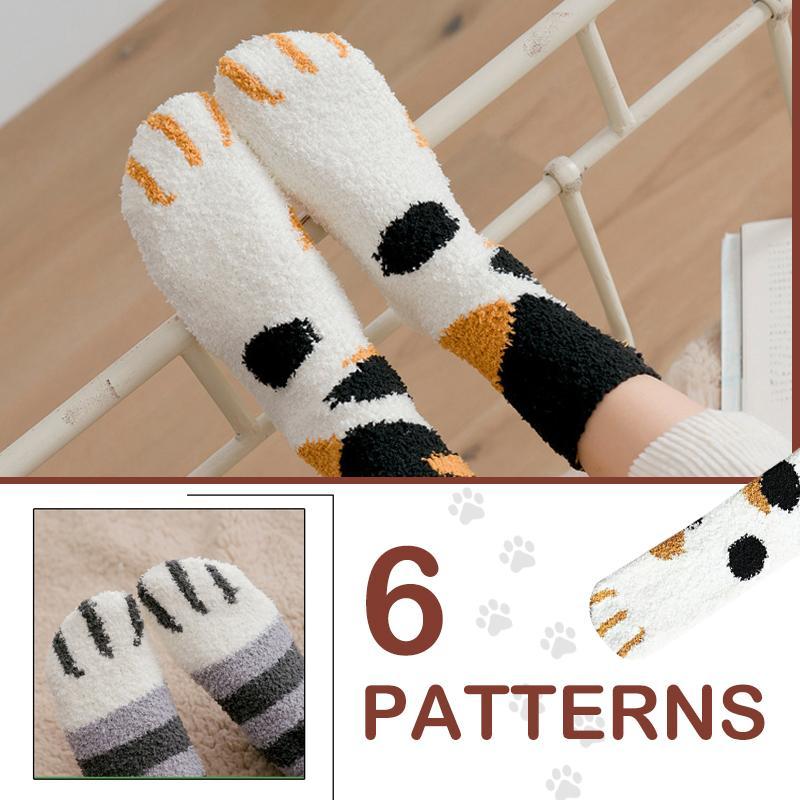 Women's novelty cat paw print ankle socks in black with white pads, warm and cozy winter footwear