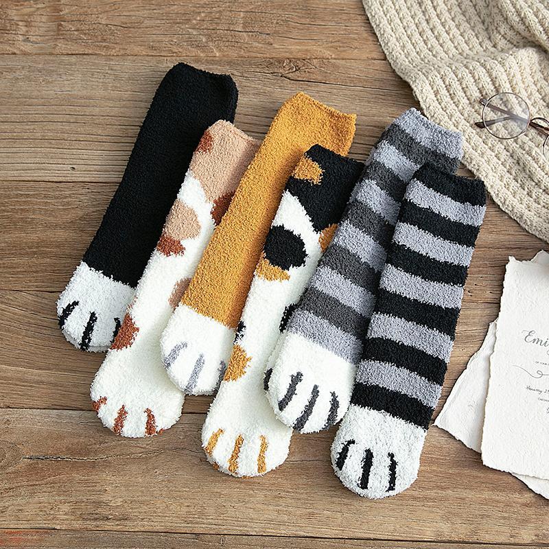 Close-up of a pair of women's cozy cat paw print ankle socks, featuring soft fabric and detailed design