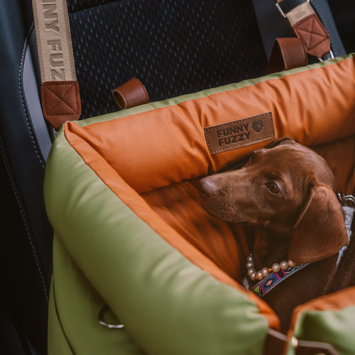 Cozy dog travel bed: faux leather car seat with safety straps. Perfect for small pets on the go.