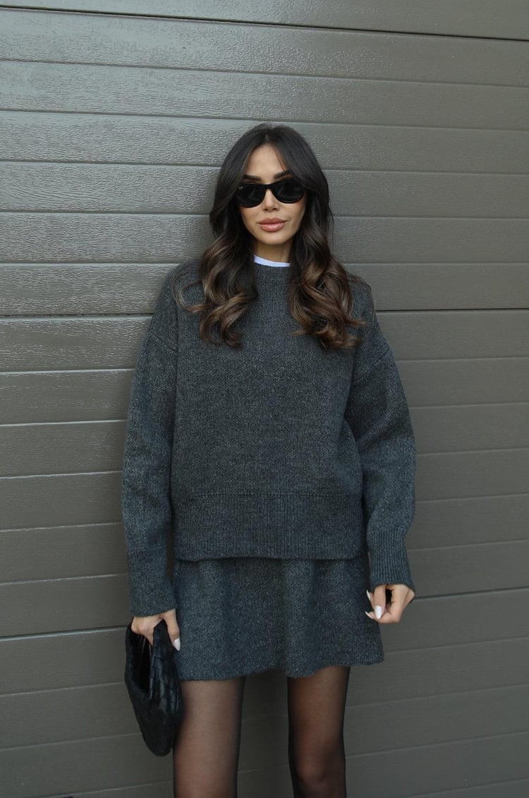 Casual women's sweater and mini skirt set in a soft knit fabric, ideal for everyday wear.