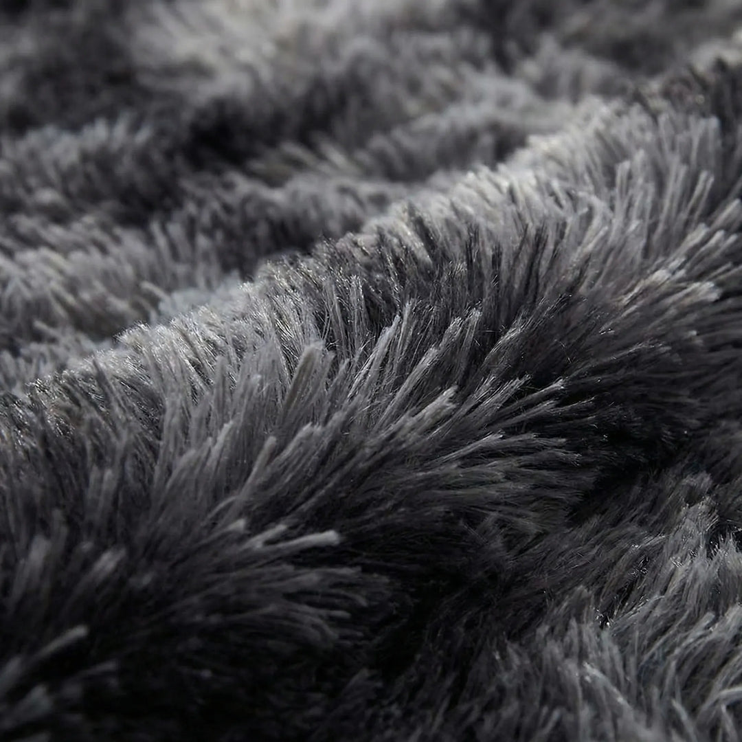 Vibrant tie-dye round area rug with Flowique wave pattern, a modern statement piece for home decor.