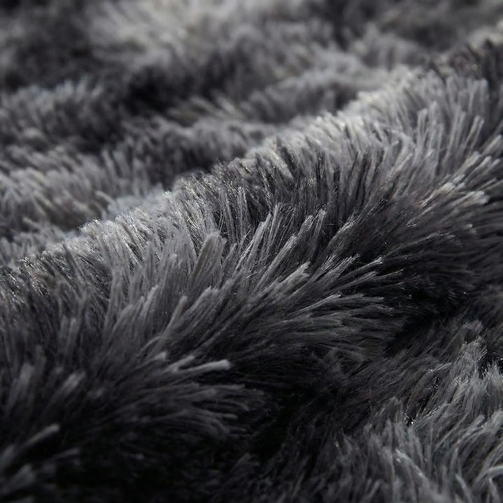 Vibrant tie-dye round area rug with Flowique wave pattern, a modern statement piece for home decor.
