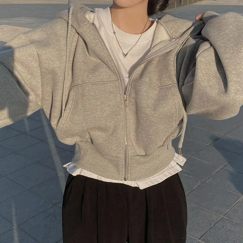 Cozy women's cropped zip-up hoodie in a soft fabric, ideal for winter casual wear & layering.