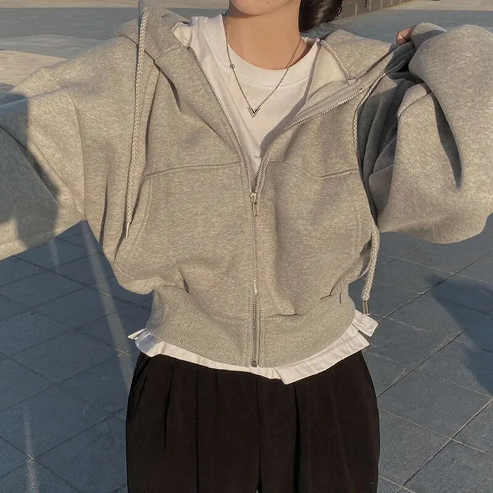 Cozy women's cropped zip-up hoodie in a soft fabric, ideal for winter casual wear & layering.