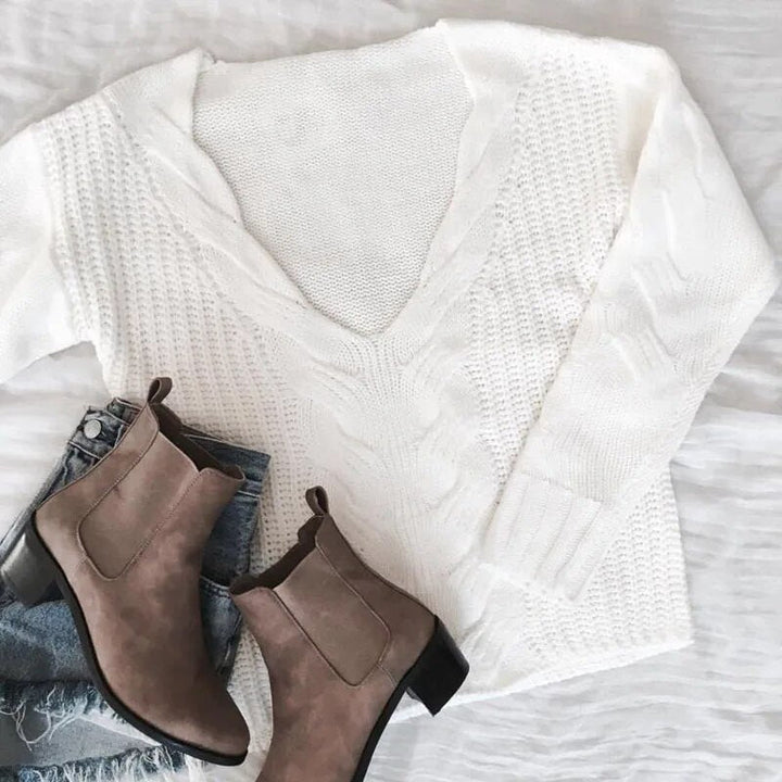 Soft knitted long sleeve sweater for women, offering comfortable and relaxed everyday style.