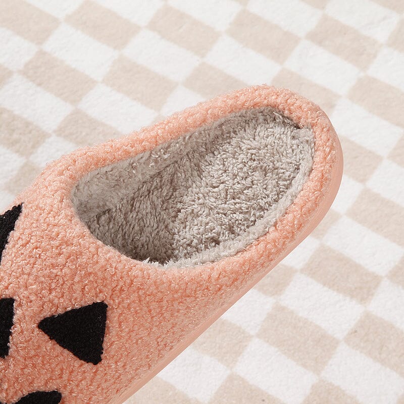 Comfortable women's plush slippers in an orange pumpkin design, ideal for fall lounging.